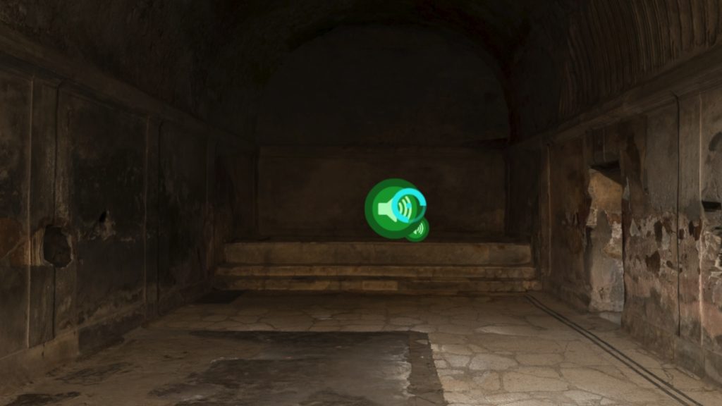 An image inside a building with a green circle containing a speaker. Overlaying this circle is a smaller circle with the outline thicker around three-quarters of it. 