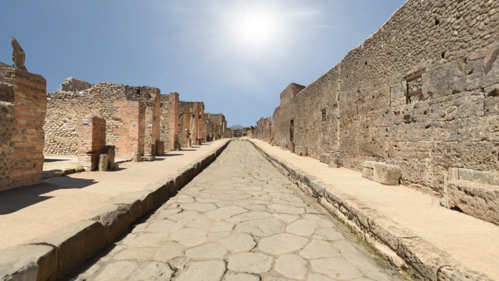 View from middle of the street looking toward the horizon with remains of building walls on both sides