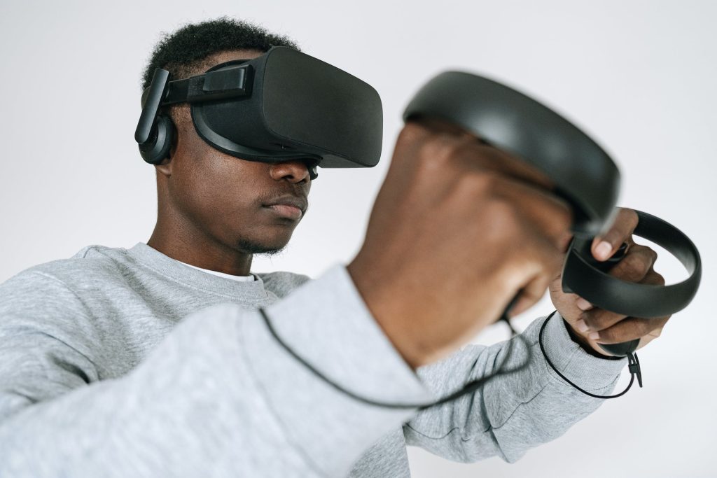 Man wearing headset and holding up controllers
