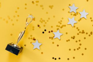 Trophy, stars, and confetti