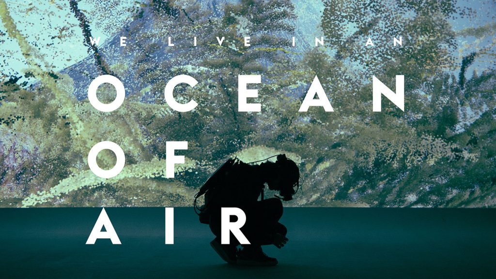 Silhouette of a diver in front of water image with text "We Live in an Ocean of Air"
