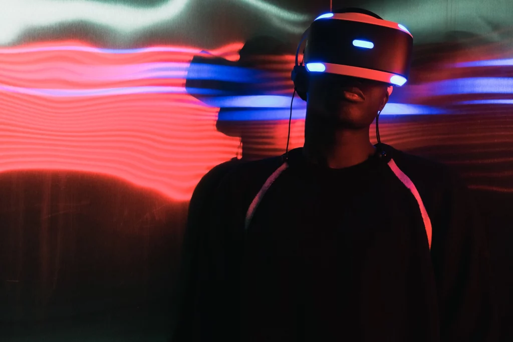 Man in VR glasses in illuminated room