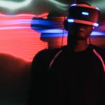 Man in VR glasses in illuminated room