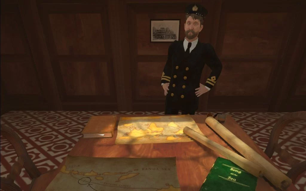 The captain stands behind his desk with maps laid out in front of him