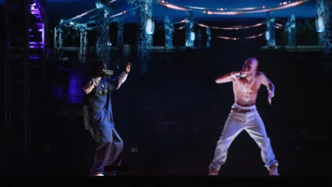 Snoop Dogg performing with Tupac Shakur (in "hologram" form) at Coachella Music Festival, 2012. (Christopher Polk/Getty Images)