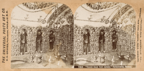 An stereoscopic photo of the Roman catacombs showing a wall of bones and three complete skeletons.