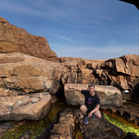 Luke sitting near the coast