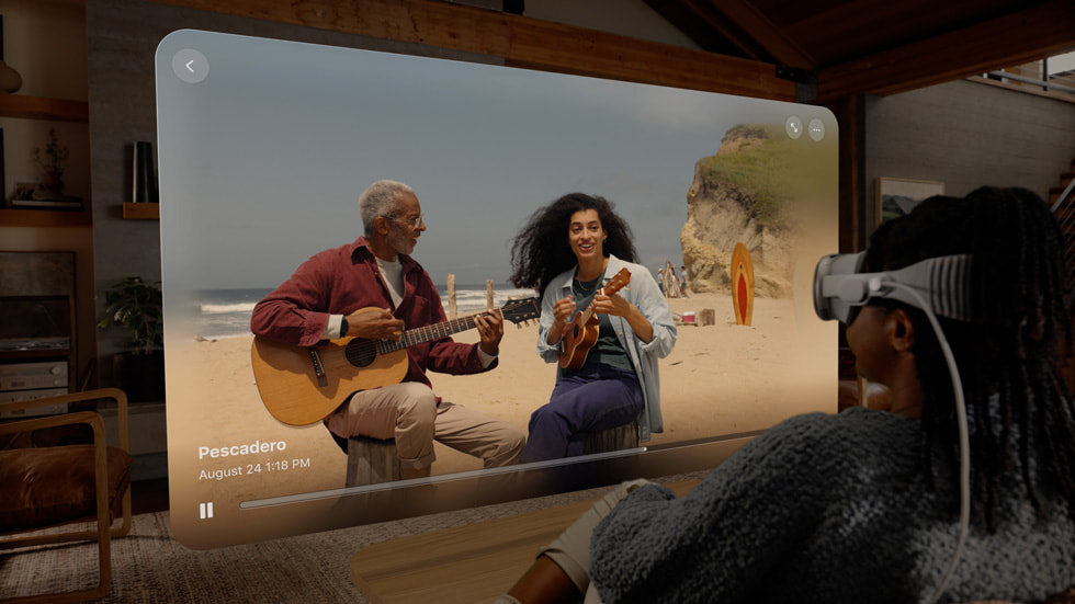 A man wears the Apple Vision Pro headset while watching a 3d video clip